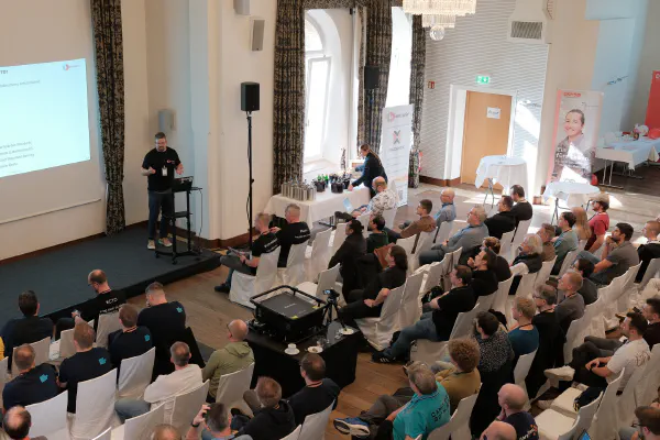 A talk in the main hall of the Palace St. George, seen from the back of the room
