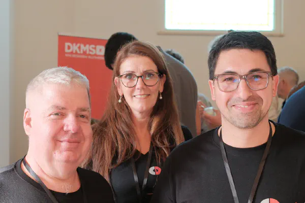Three attendees posing for a photo